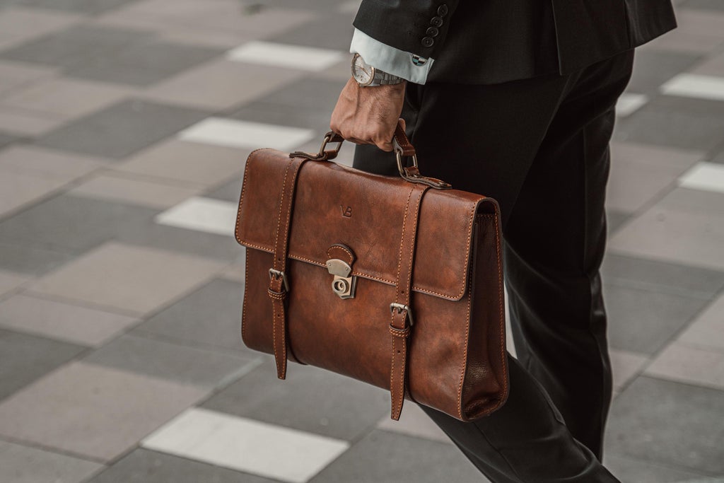 no3 brown leather briefcase held by model in suit