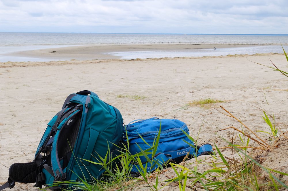 Osprey backpacks on a beach