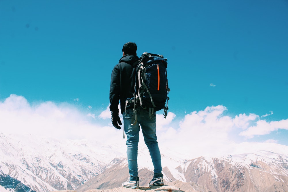 Man standing on top of a mountain