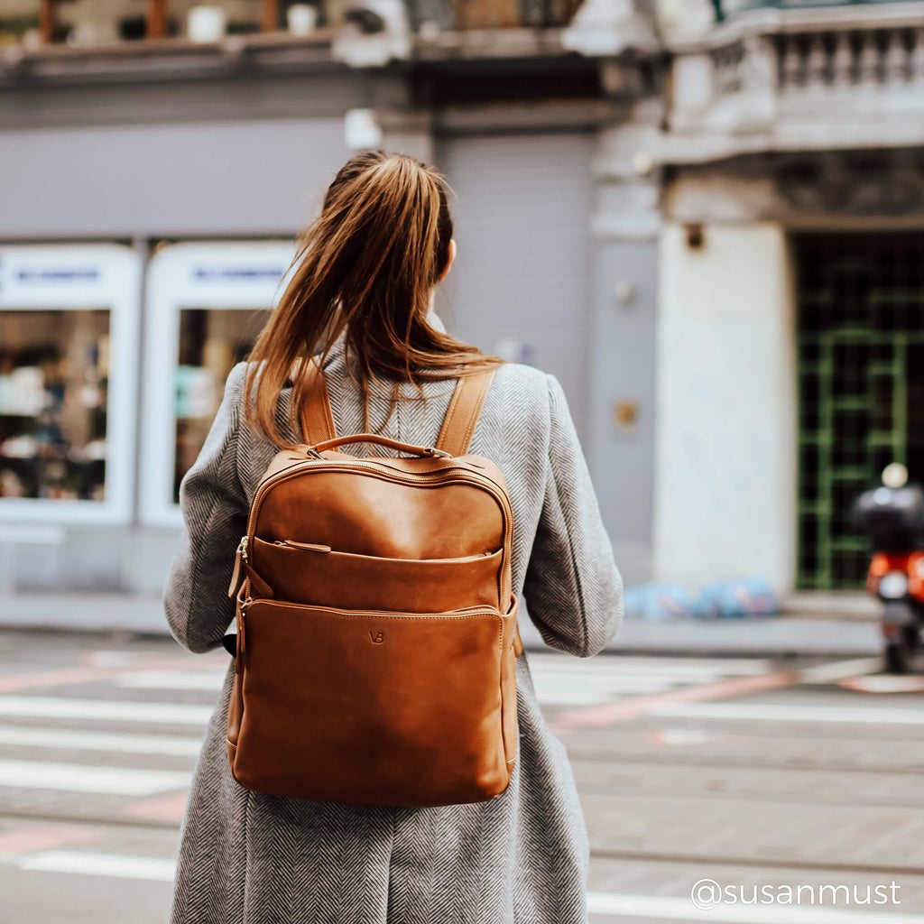 women wearing liberty leather backpack while commuting to work