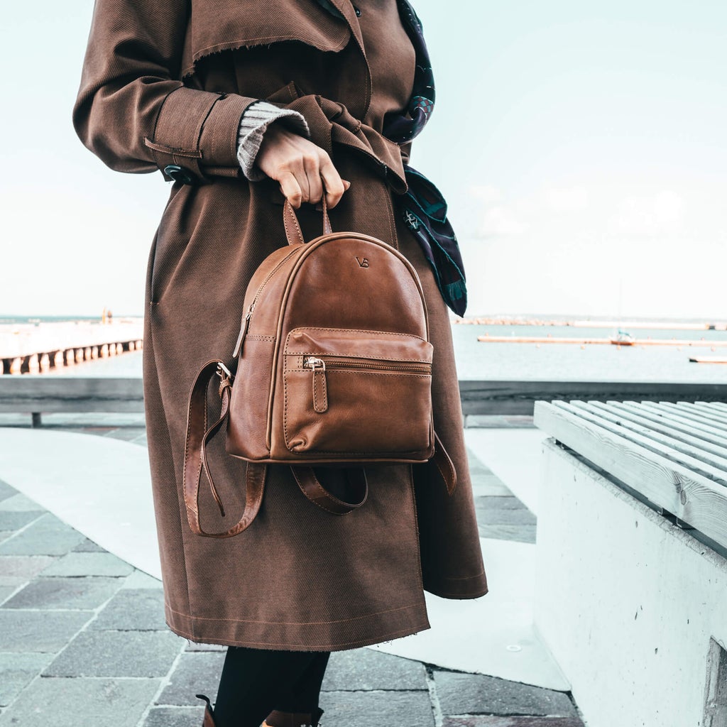 women carrying bella leather backpack on the way to work