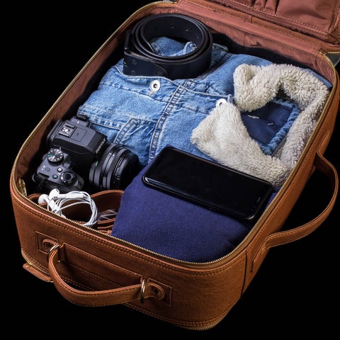 Travel luggage with travel items like clothes and camera in it