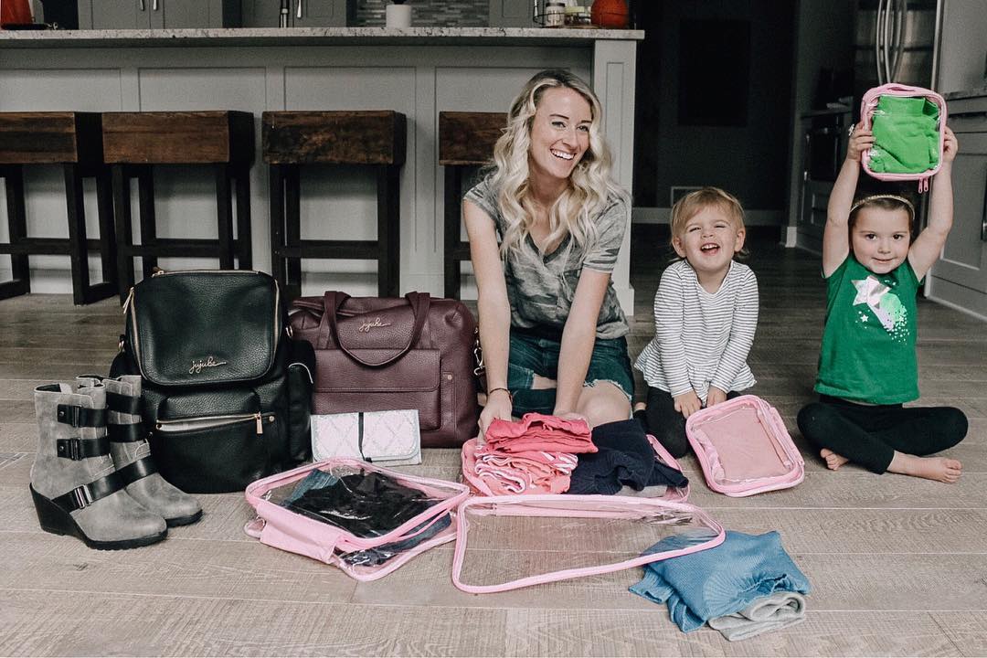 Mom packing travel essentials with two kids