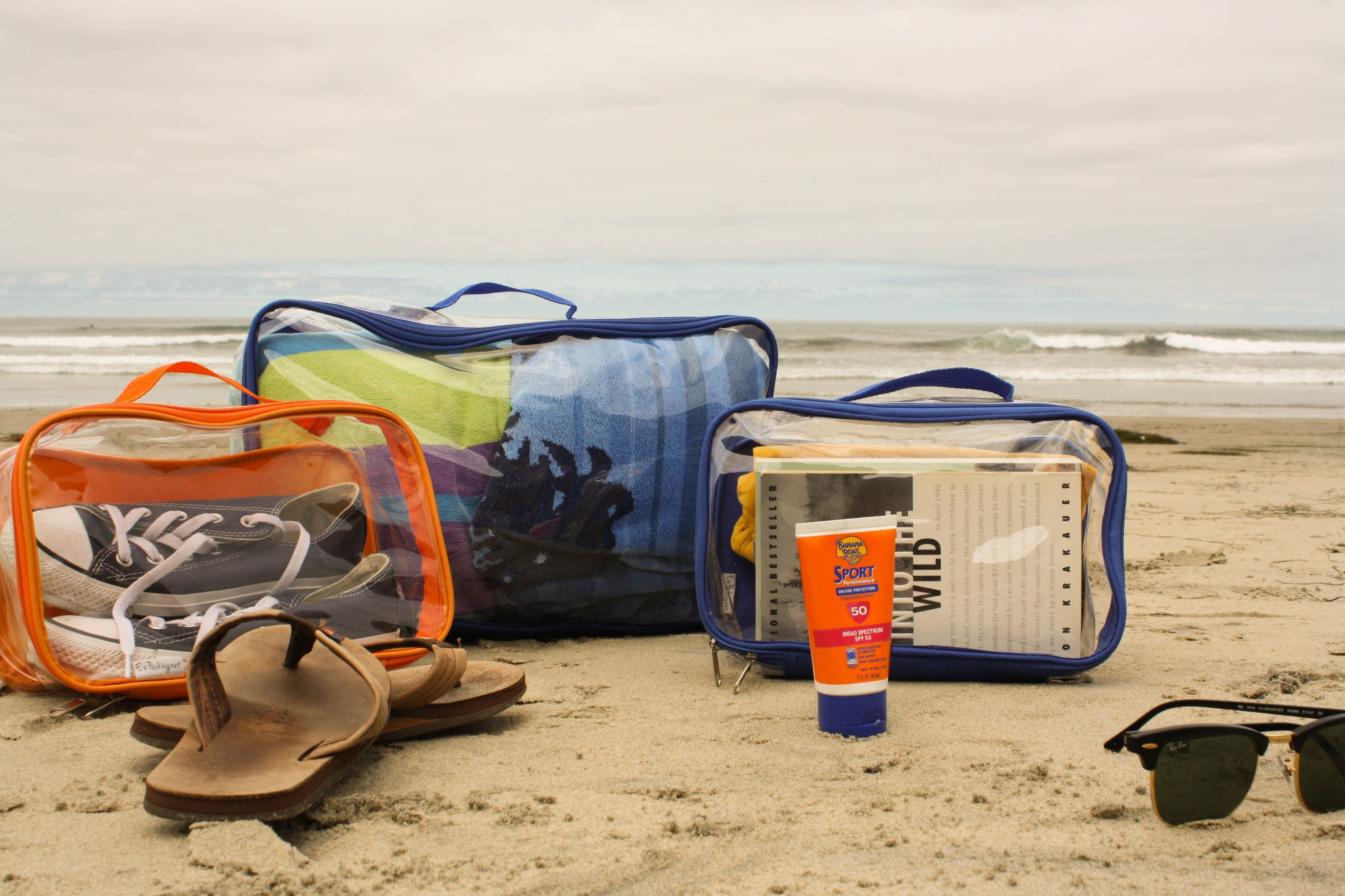 Beach essentials packed in clear packing cubes