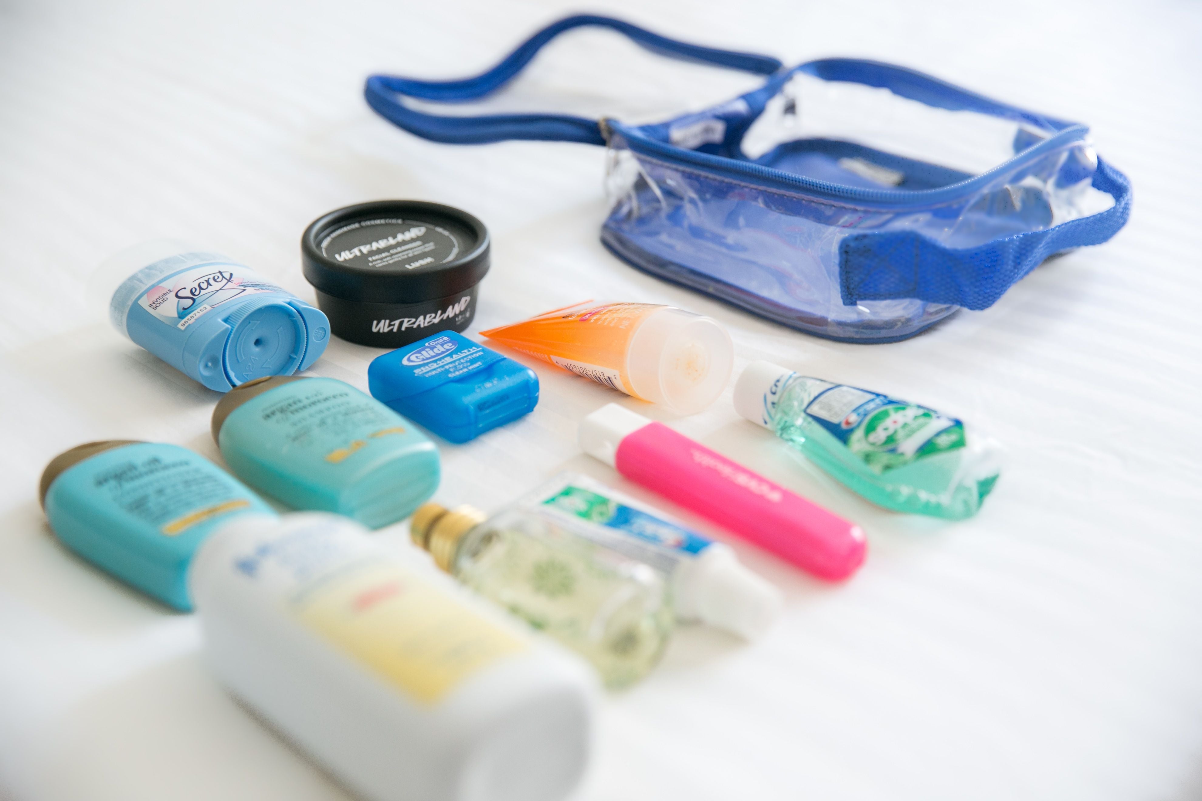 Unpacked travel size bottles and TSA approved toiletry bag