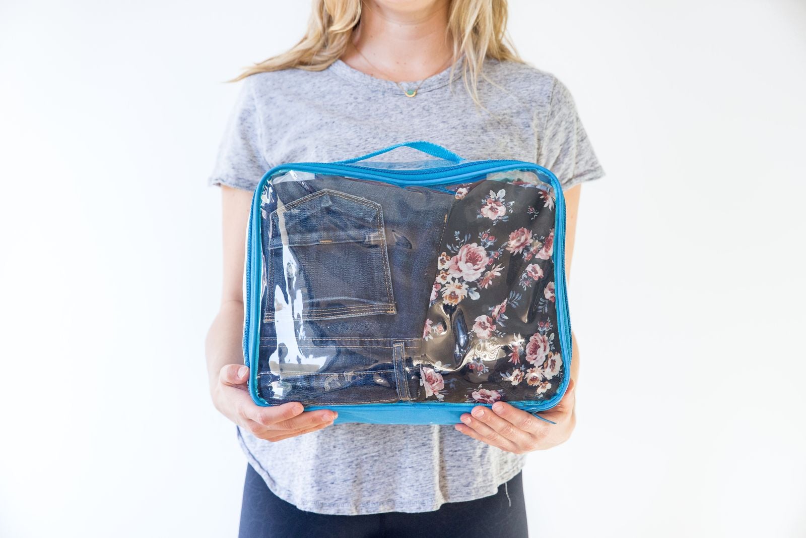 Jeans packed in turquoise clear packing cube