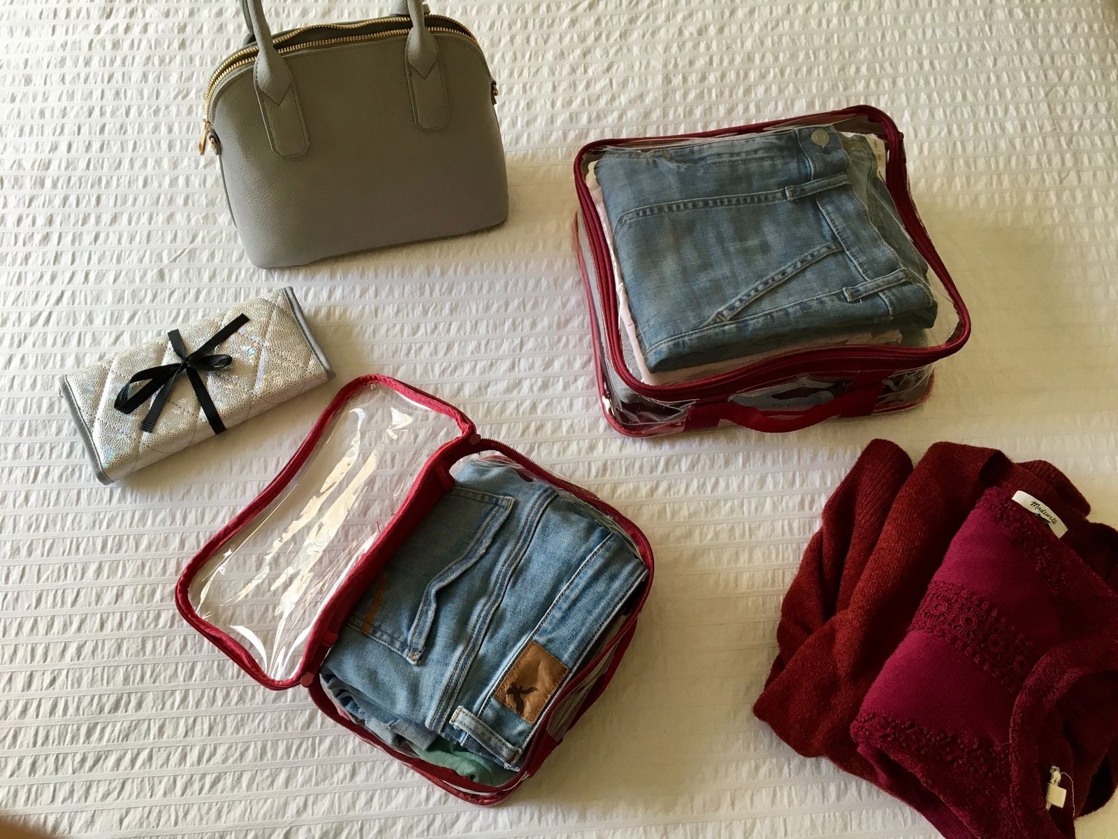 Folded jeans and shirts packed in clear packing cubes