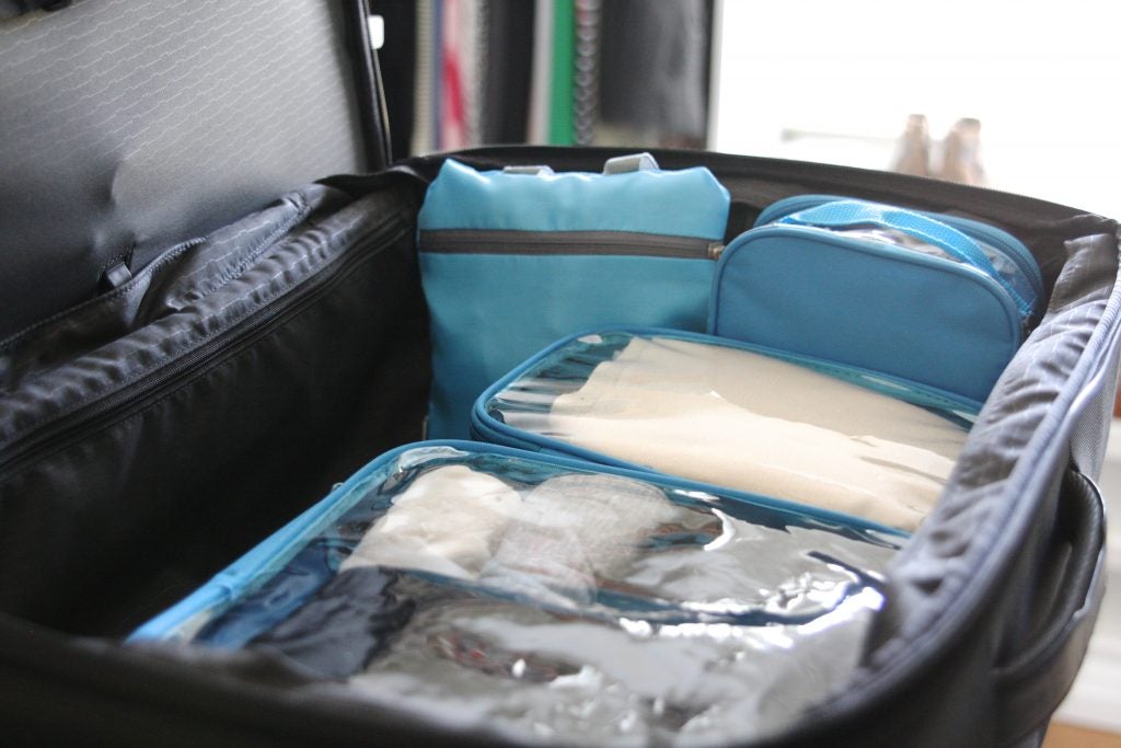 Organized suitcase using clear packing cubes