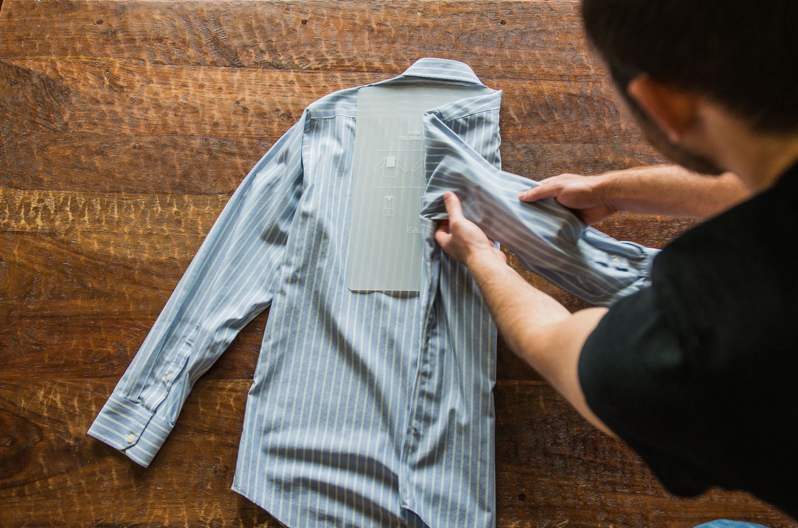 Folding long sleeved shirt using travel folding board