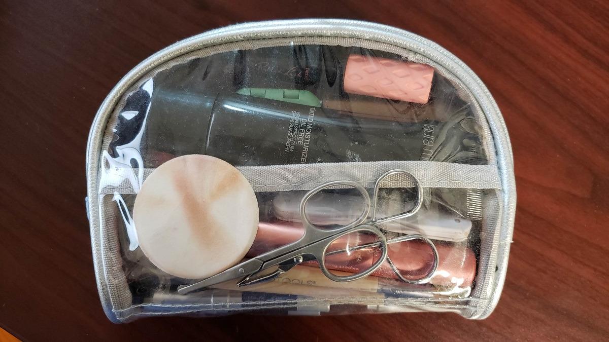 beauty essentials in a clear pouch