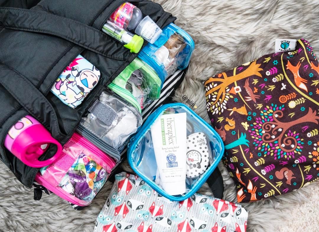 diaper bag organized using clear packing cubes