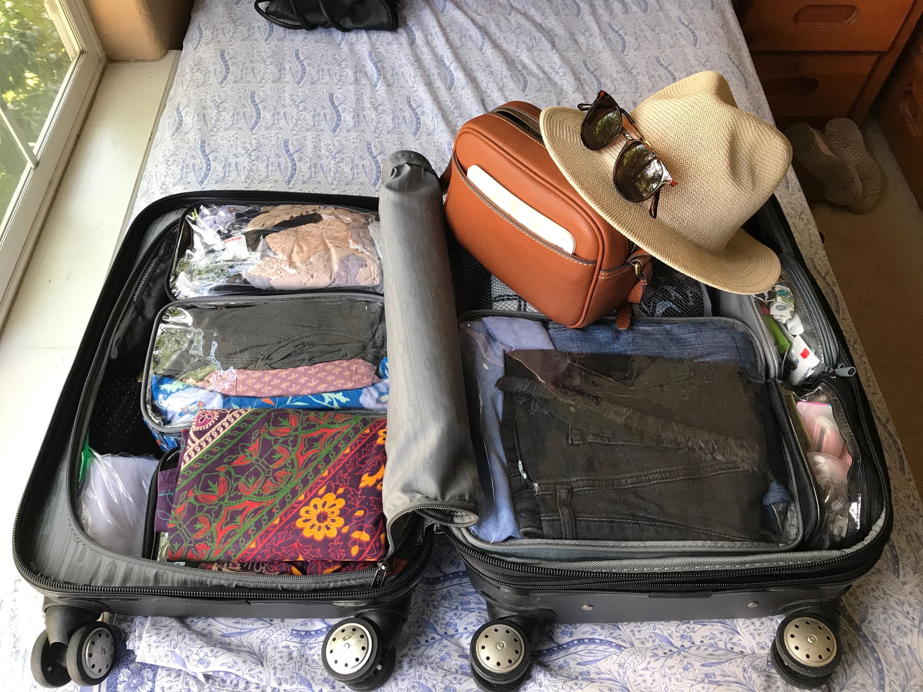 Organized essentials in a suitcase using clear cubes