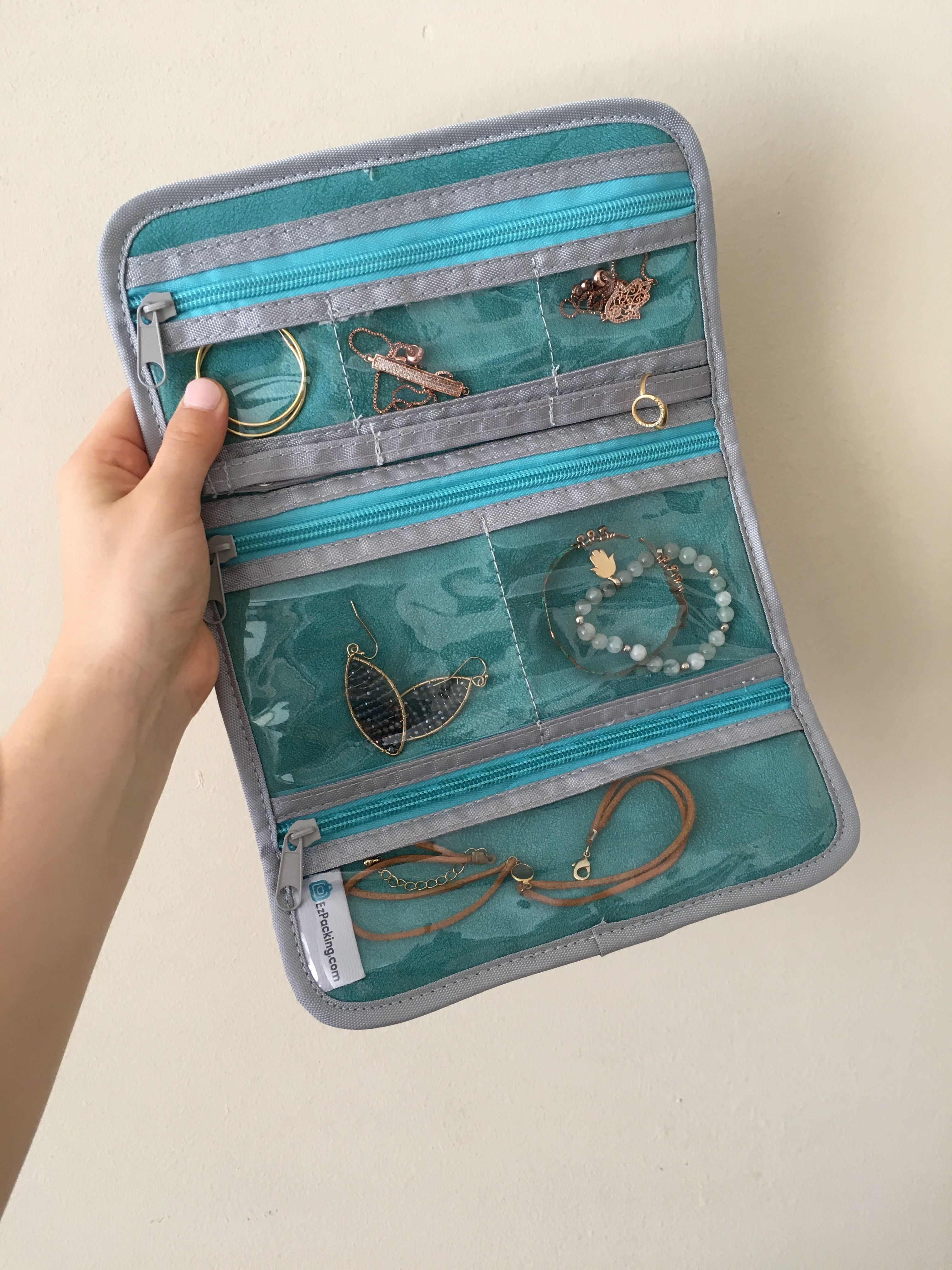 Accessories organized in a travel jewelry roll