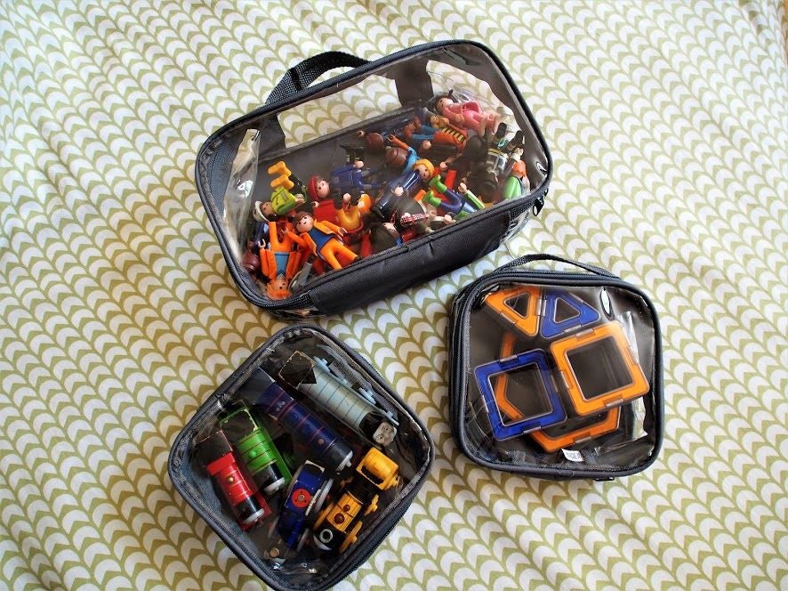 Toys organized in small and extra small packing cubes
