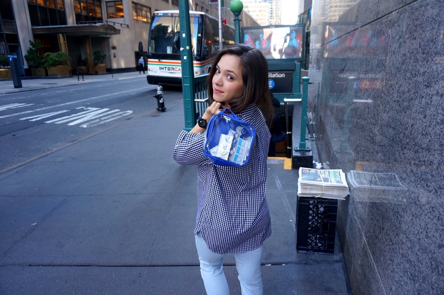 Young woman on the street carrying an extra small packing cube