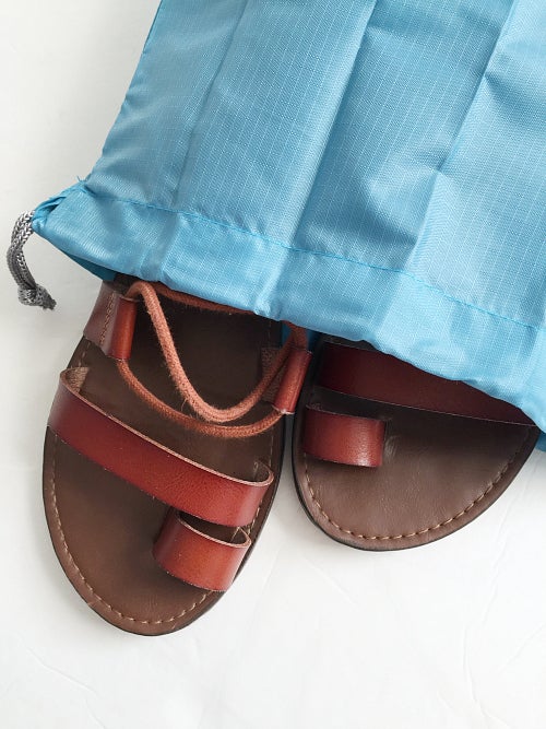 Flat sandals in a shoe bag for summer vacation