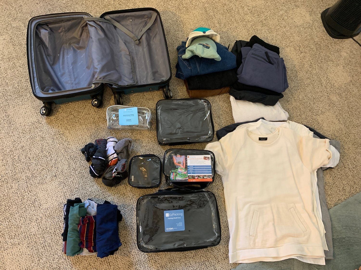Packing men’s clothes in packing cubes for weekend trip