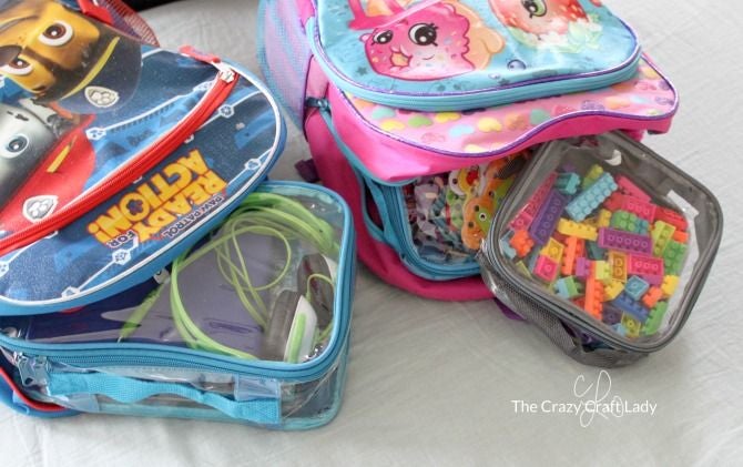 Kids toys, electronics and other travel items organized in packing cubes for backpacking
