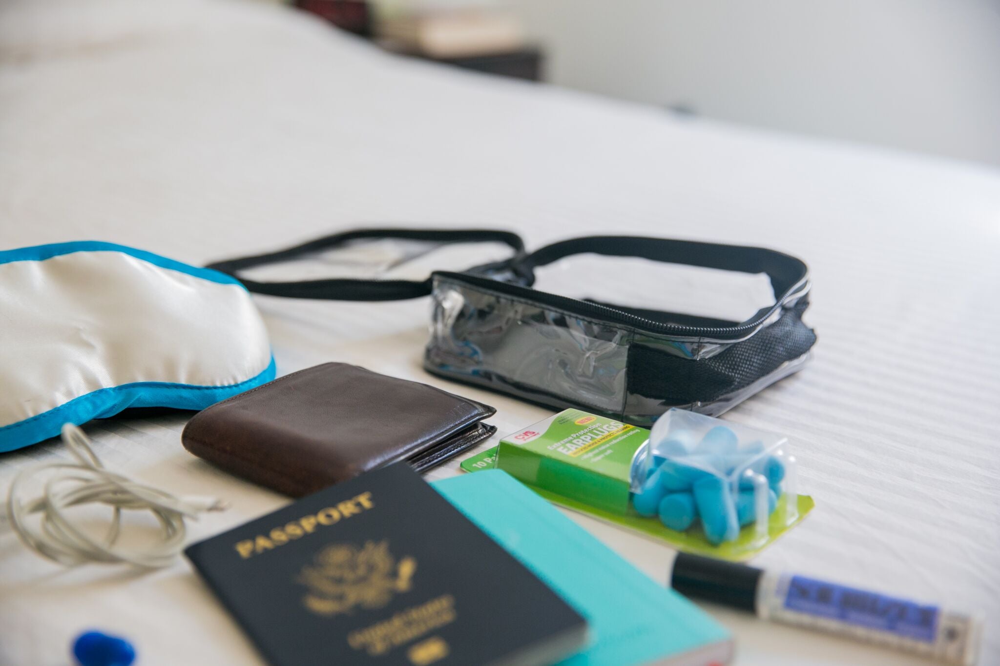 Earplugs, eye mask and other sleeping essentials in black packing cube