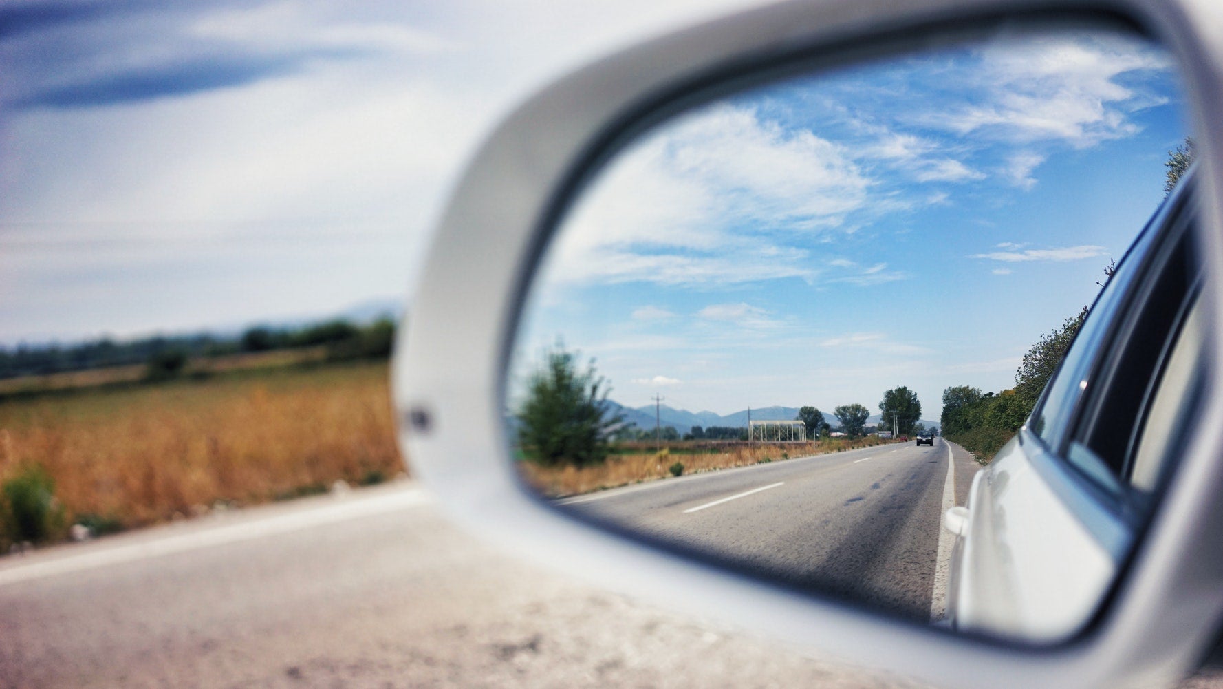 Side mirror view during road trip 