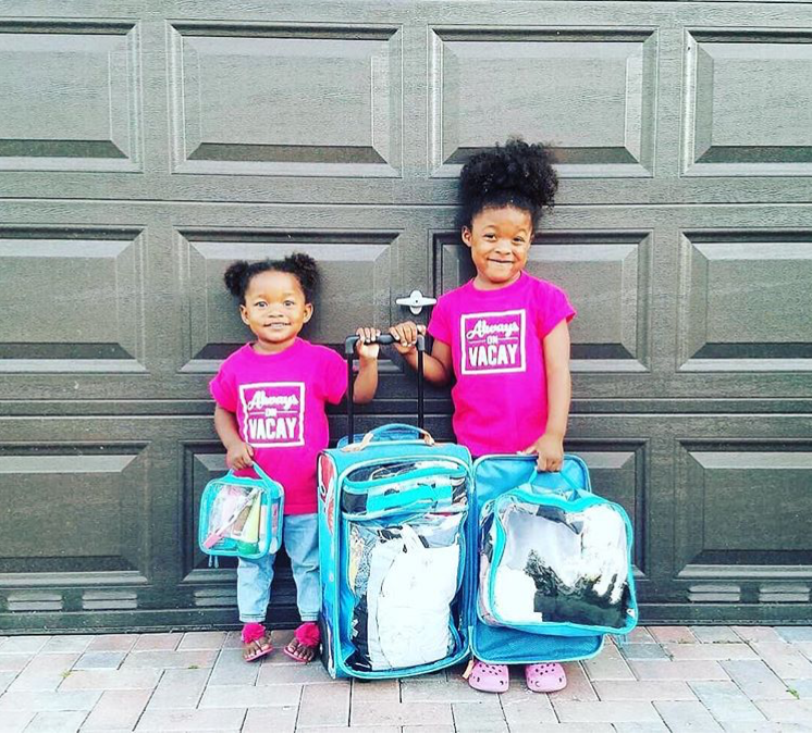 two little girls with a suitcase and packing cubes