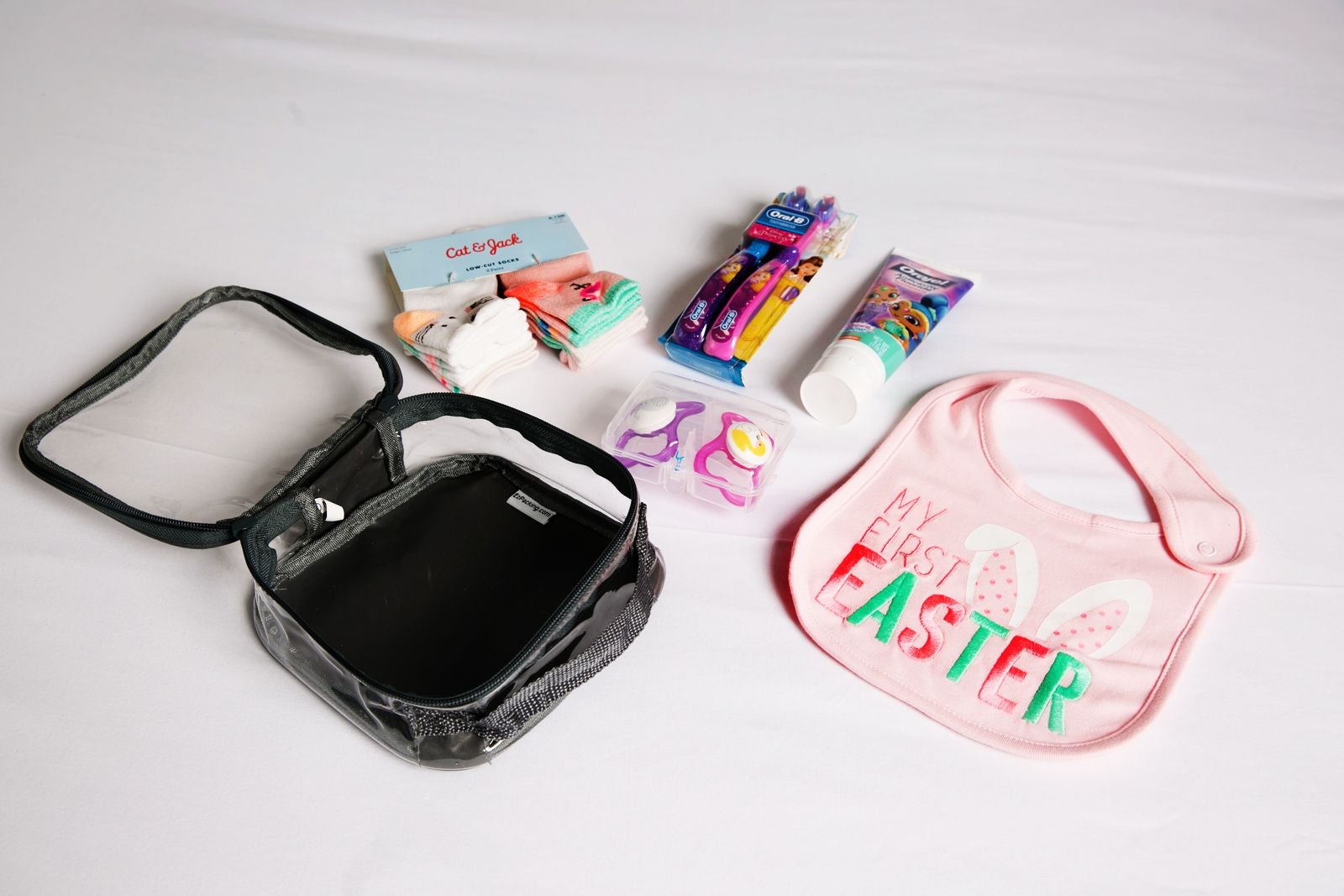 baby bib and other essentials in an extra small cube