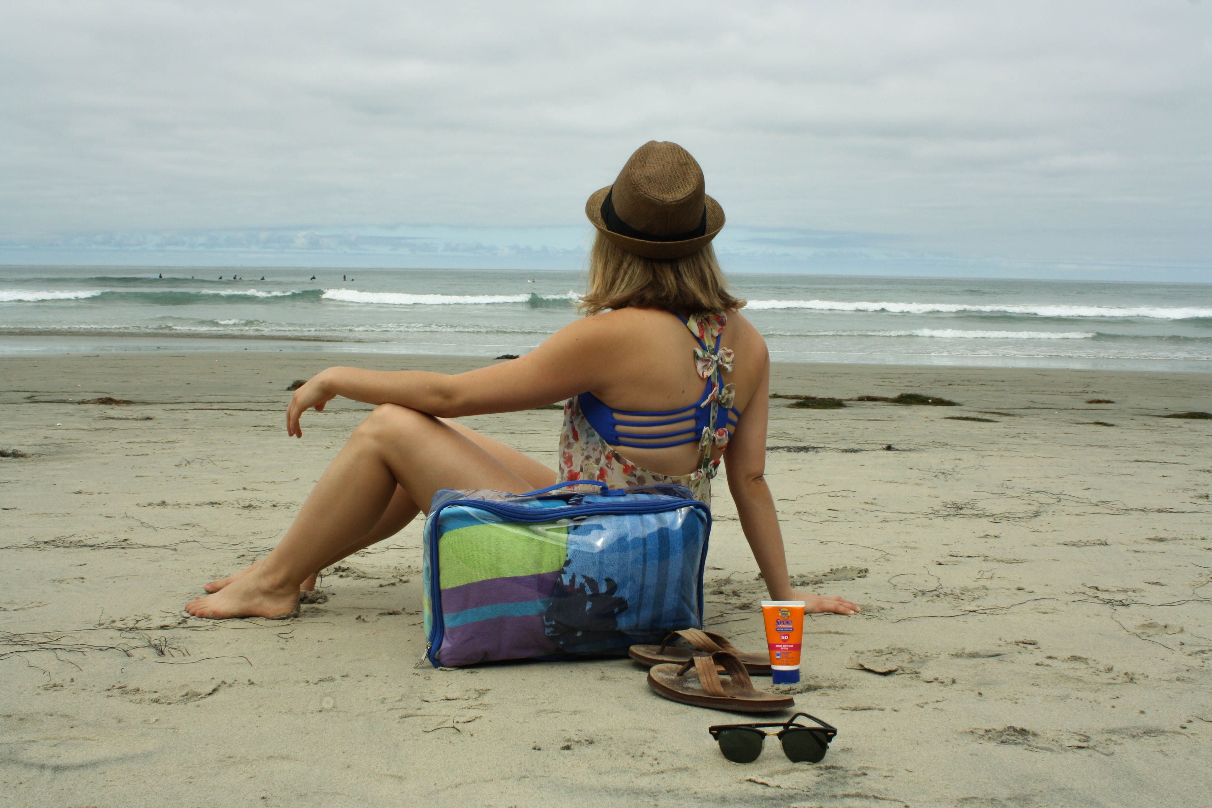 Woman on the beach with large cube
