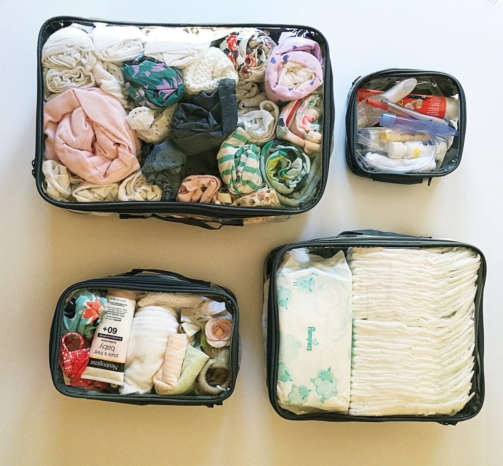Baby essentials organized in packing cubes