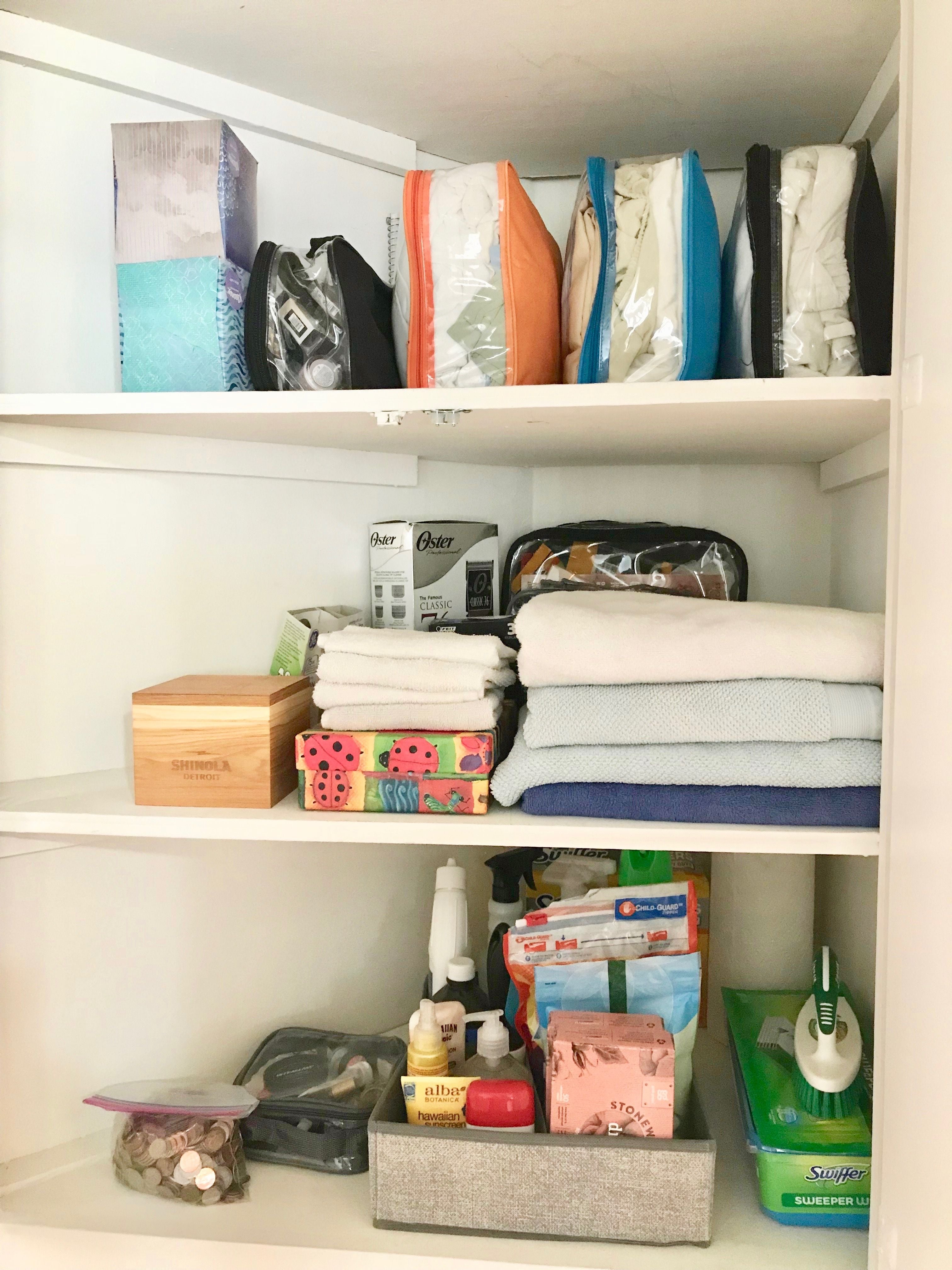 Linen closet organized with packing cubes