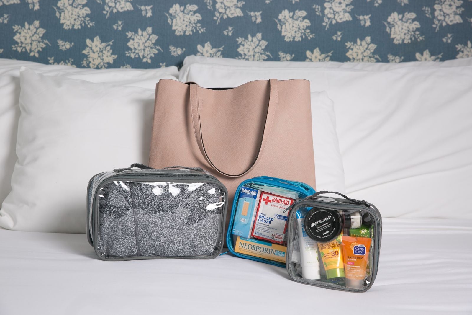 Tote bag and clear packing cubes on a bed