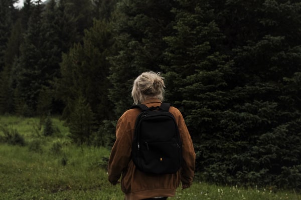 Adventure lady wears Atlas pro laptop backpack in the mountain