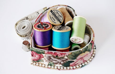 thread, bobbin, measuring tape, sewing kit