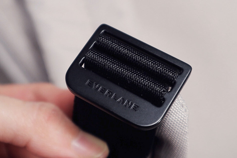 Metal shoulder strap buckles on the Everlane Renew Transit backpack