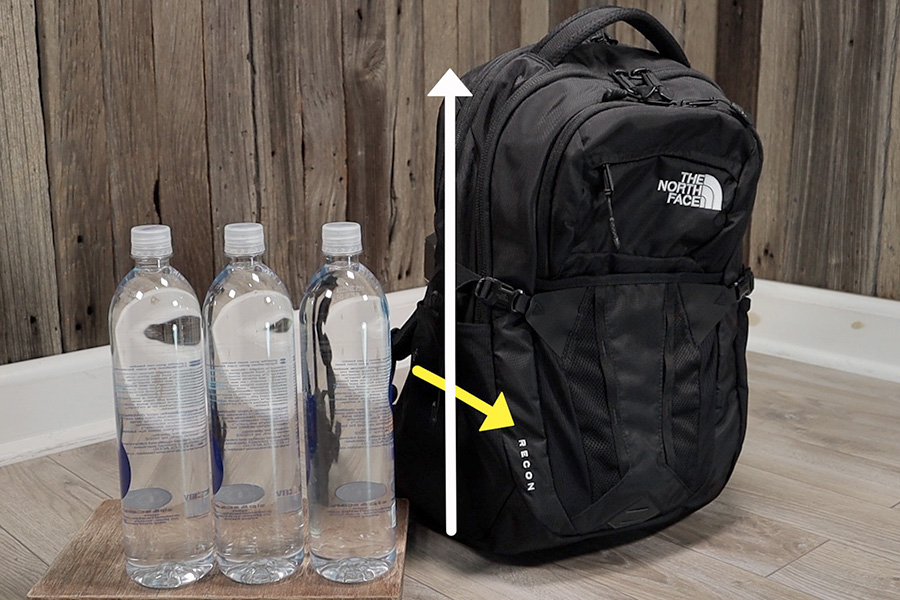 North Face Recon next to 1 liter water bottles. The extra carrying capacity can be found in the height and depth of the main compartment.