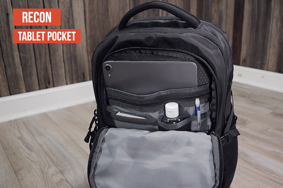 The North Face Recon has a tablet pocket on the front and the Surge does not