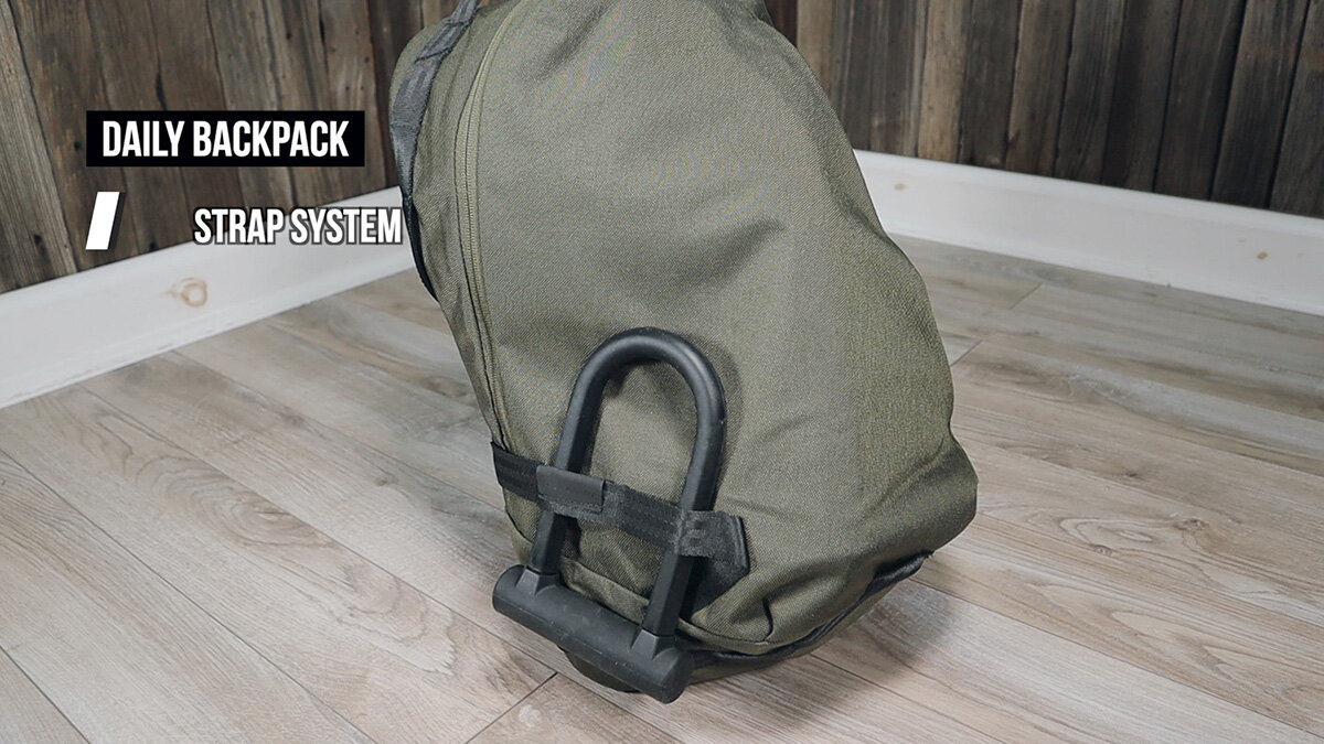 Able Carry Daily Backpack review - strap system with bike lock attached
