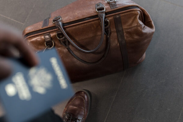 18 x 14 x 8 bags: a leather duffel with owner at the airport