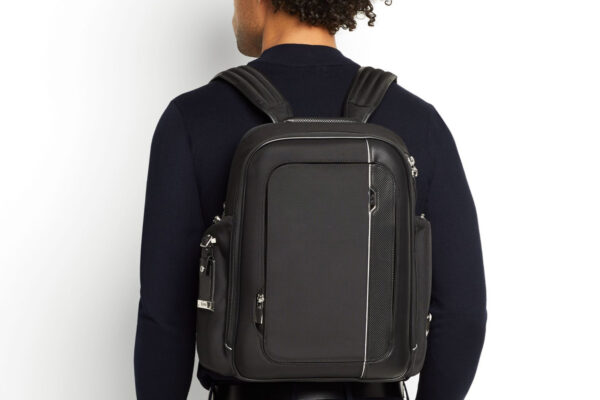 Tumi Backpacks: a man wearing a Tumi backpack