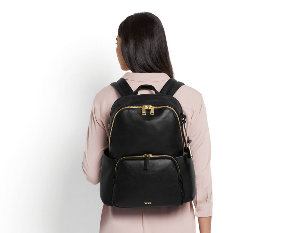 Tumi Backpacks: a woman wearing a Tumi backpack