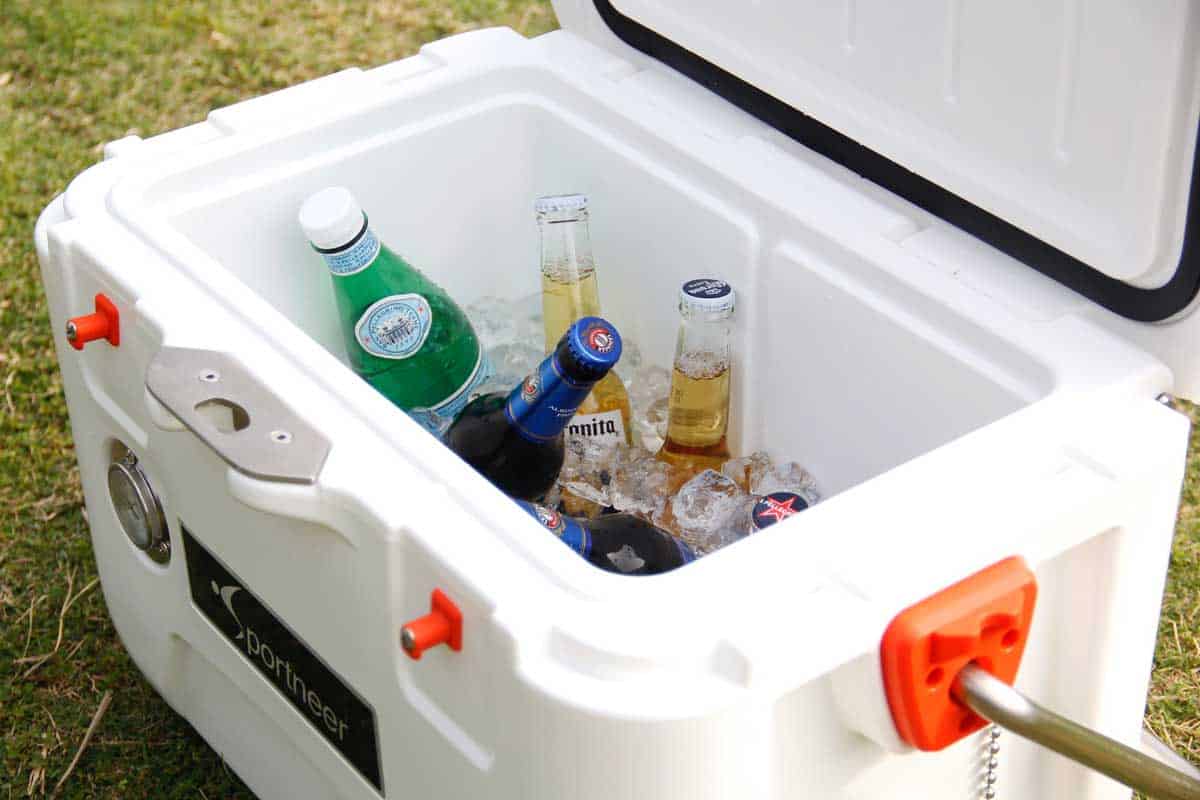 Cooler box filled with ice and beer. 