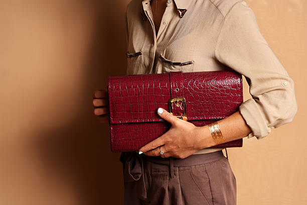 Woman holding a large wallet clutch