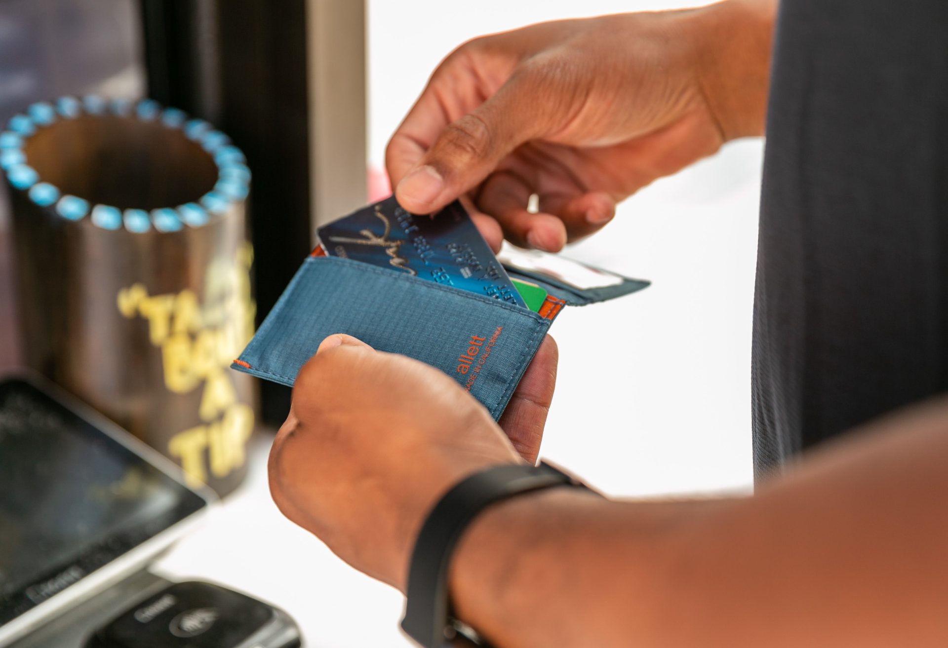 Man pulling credit card out of his Allett Hybrid Card Wallet