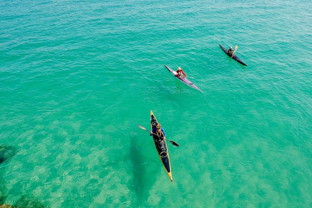 People kayaking in crystal clear waters