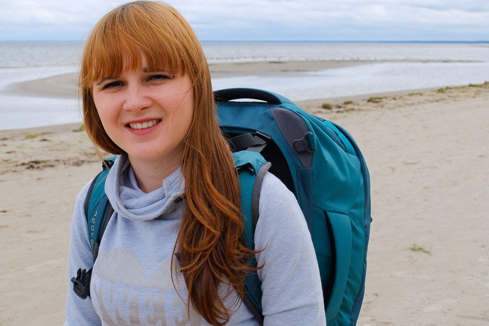 Una wearing her Osprey Fairview 40 backpack on the beach