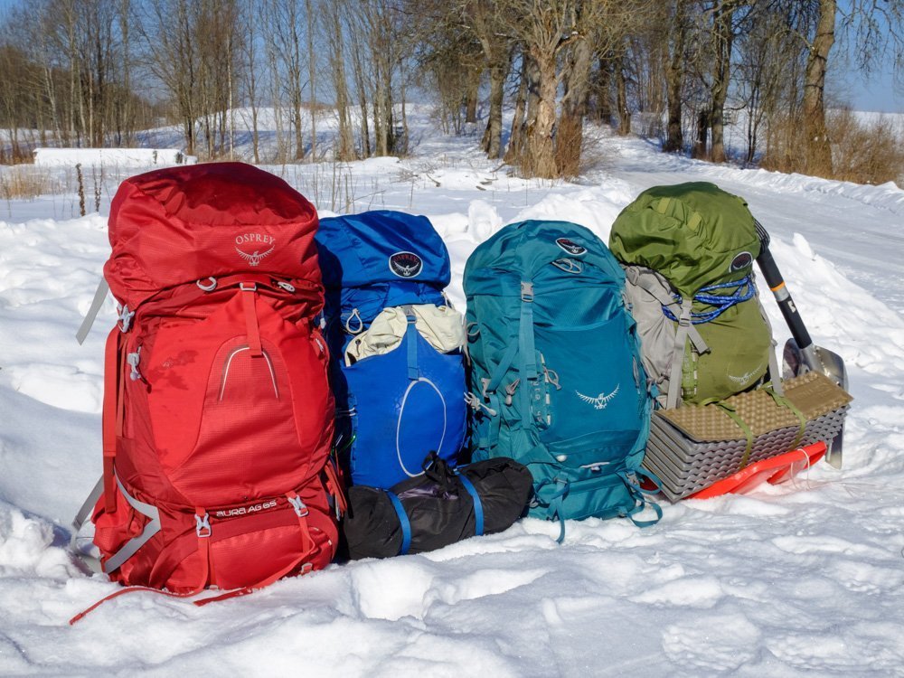 4 Osprey backpacks on the snow