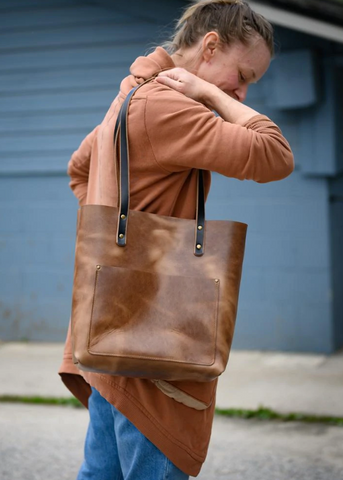 Woman carrying a leather tote bag