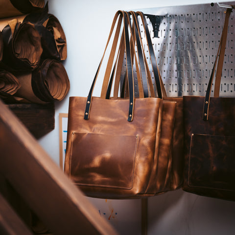 Leather bags on hooks in a leather workshop