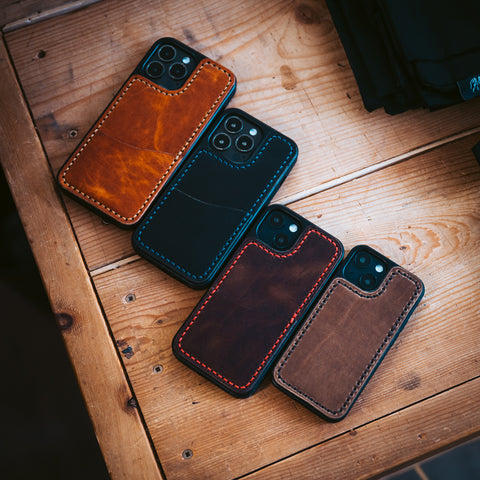 Four smartphones in durable leather cases