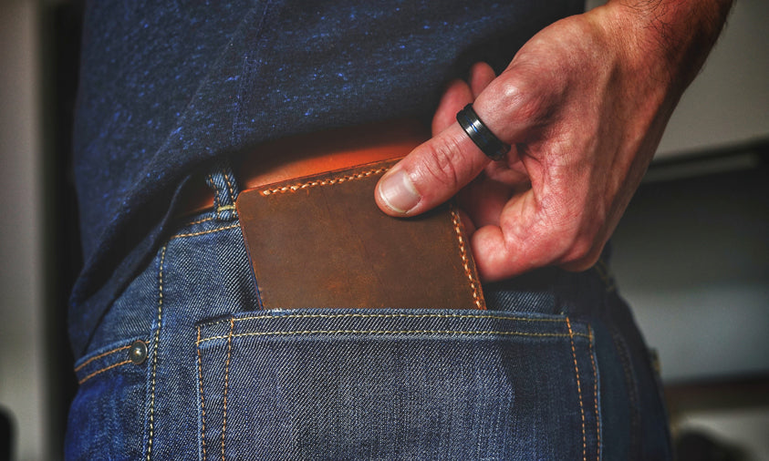 man carrying a hand stitched leather wallet in his pocket