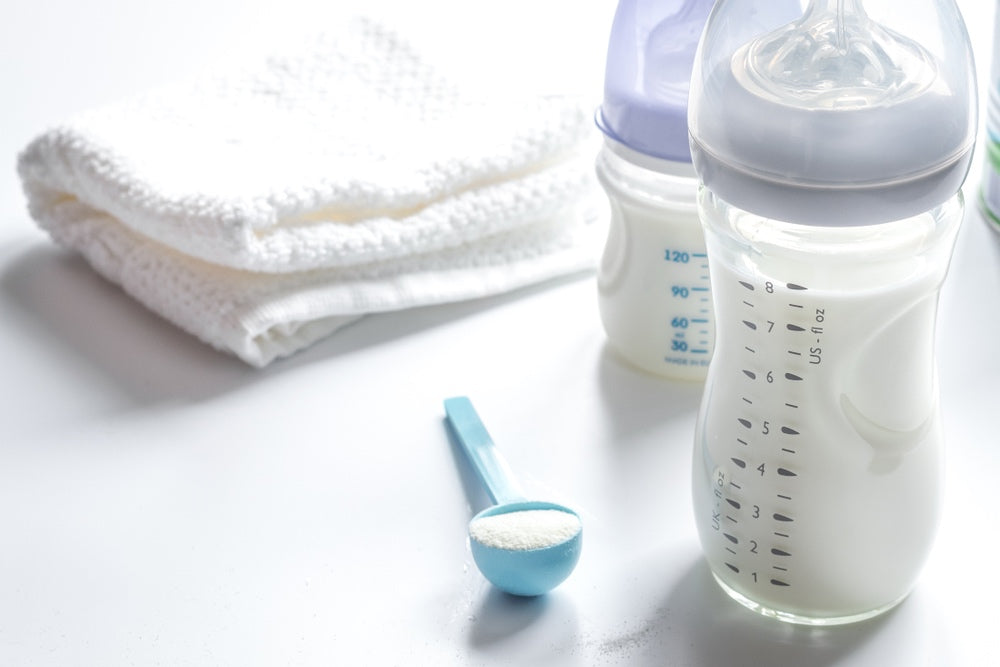 baby bottles, formula, and towels